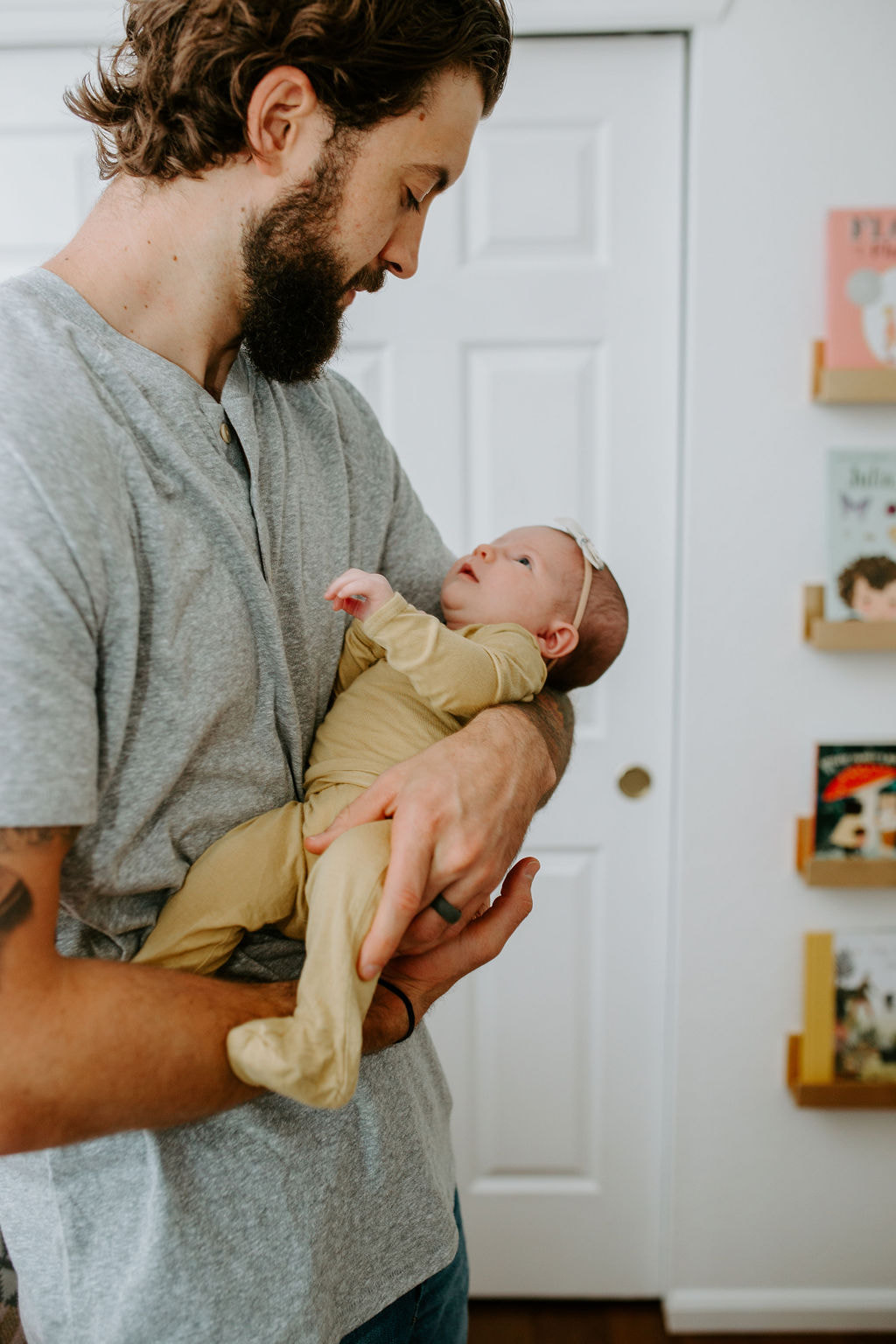 Nathan Yeargin holding baby girl, YouthfulNest Nursery Design