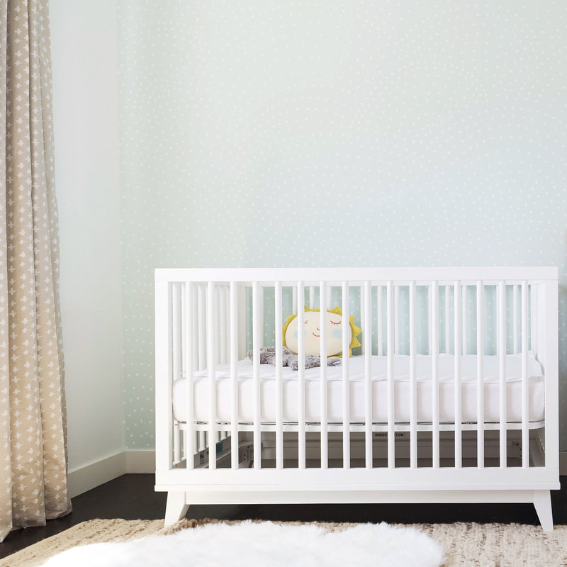 Gender Neutral Nursery with mint anewall wallpaper and white crib