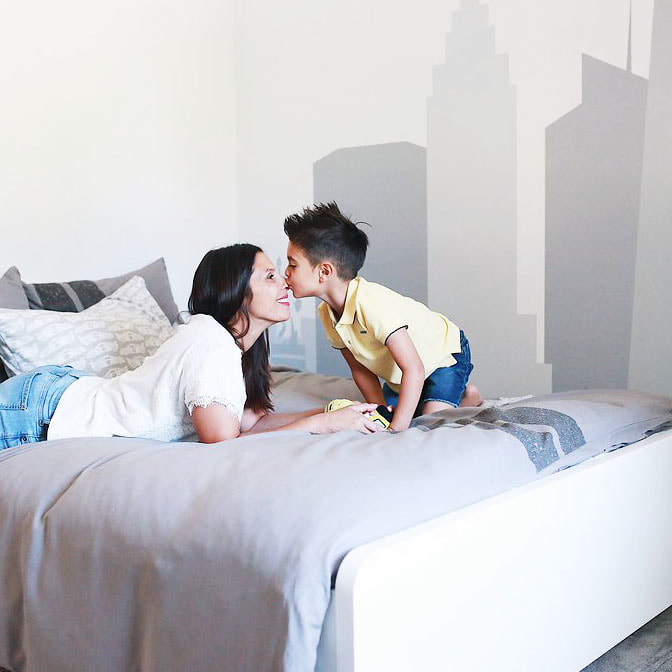 Mom and son in modern eclectic big boy bedroom designed by YouthfulNest